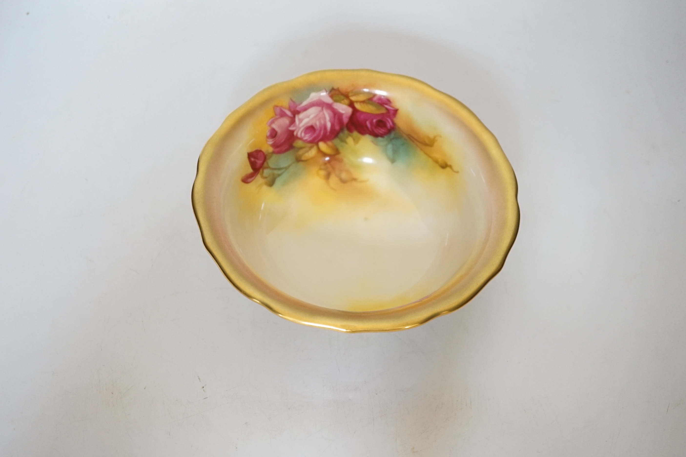 A Royal Worcester bowl decorated with roses, signed M Hunt, 8cm